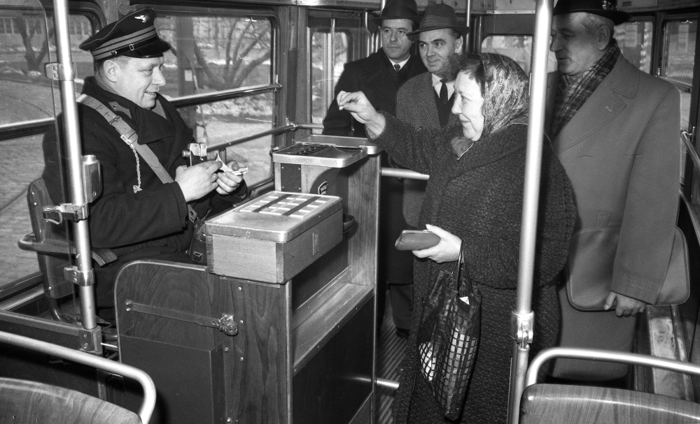 Schaffner beim Markieren der Fahrscheine für Fahrgäste in einem Zug der Type E, 
April 1965