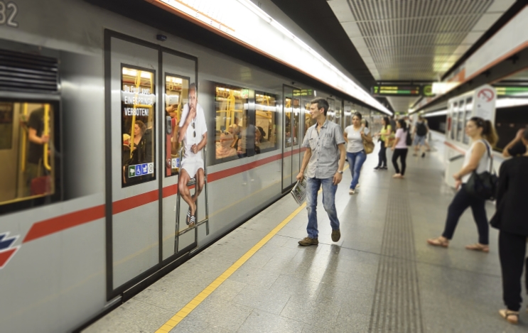 Beklebungen auf U-Bahn-Zügen machen auf das Blockieren der U-Bahn-Türen aufmerksam.
